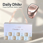 Rose gold prayer reminder device with packaging on a light background